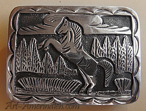 Boucle de ceinture américaine en argent, bijou amérindien Navajo représentant un cheval cabré devant un paysage Western