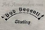 Bob Becenti over a curved arrow hallmark on Navajo jewelry