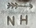 NH under or above a right pointing arrow mark on jewelry is Nelson Howard
