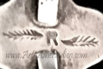R and feathers mark